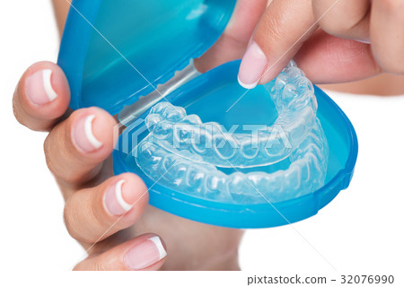 Female arms showing clear aligners in case 32076990