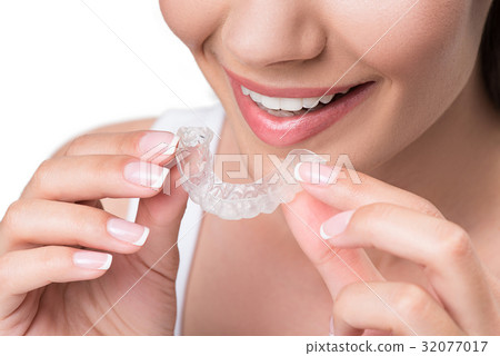 Joyful young woman undergoing clear-aligner 32077017