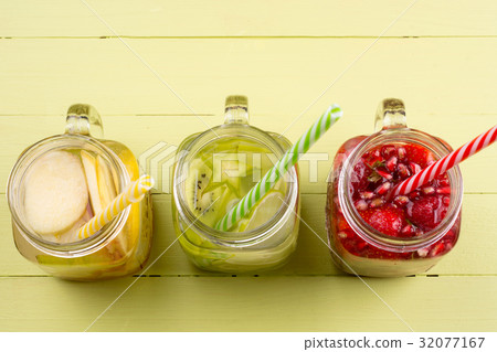 Fresh fruits flavored water in jars 32077167