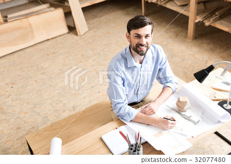 Jolly youthful wood master working on design of Jolly youthful wood master working on design of 32077480