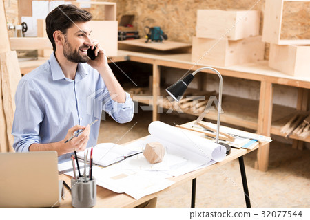 Jolly lumber craftsman communicating by gadget Jolly lumber craftsman communicating by gadget 32077544