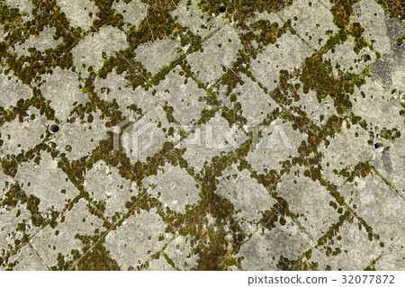 Old stone wall covered with moss 32077872