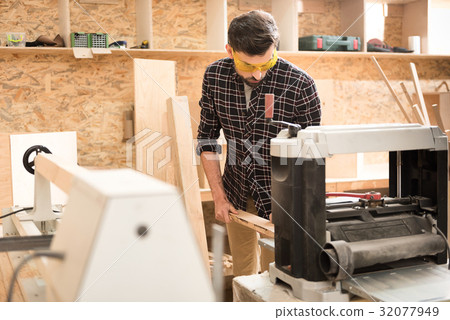 Energetic carpenter is laboring in workshop Energetic carpenter is laboring in workshop 32077949