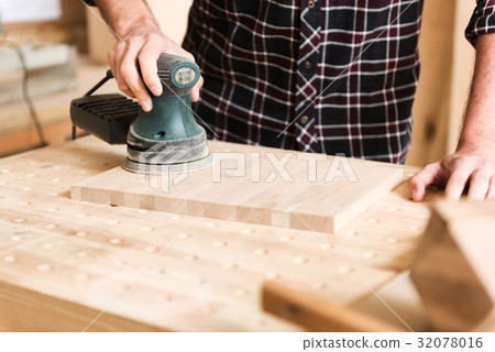 Young carpenter is working in his workshop Young carpenter is working in his workshop 32078016