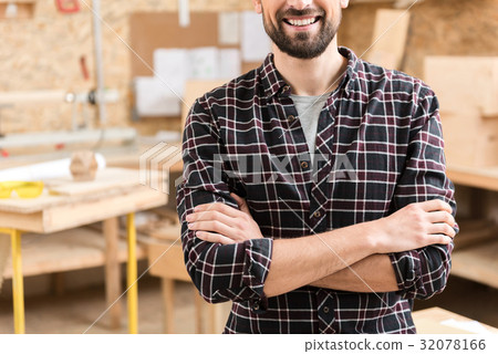 Confident woodworker is relaxing at work 32078166
