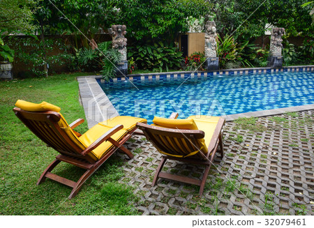 Relaxing chairs at beautiful swimming pool 32079461