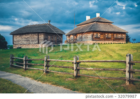 Wooden ethnic houses on rural landscape Wooden ethnic houses on rural landscape 32079987