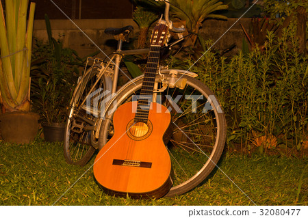 The bike is parked in the backyard and there is a The bike is parked in the backyard and there is a 32080477