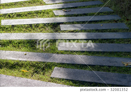 cement pathway on grass in garden 32081352