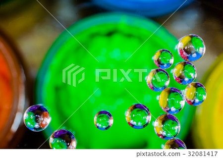 colorful bubble above green plastisol ink in can. 32081417