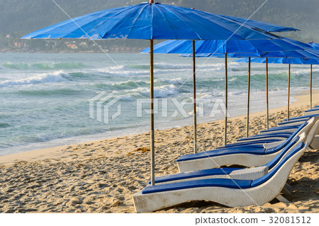 blue umbrellas and beach chair 32081512