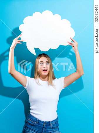 Young woman holding a speech bubble Young woman holding a speech bubble 32082442