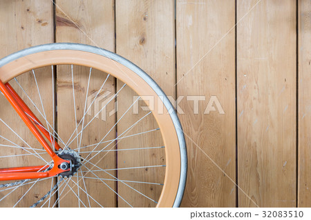 bicycle parked with wood wall, close up image 32083510