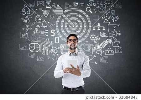 Businessman using digital tablet in front of icons 32084845