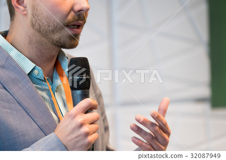Speaker at conference holding microphone Speaker at conference holding microphone 32087949