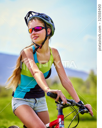 Woman traveling bicycle in summer park. Woman traveling bicycle in summer park. 32088400