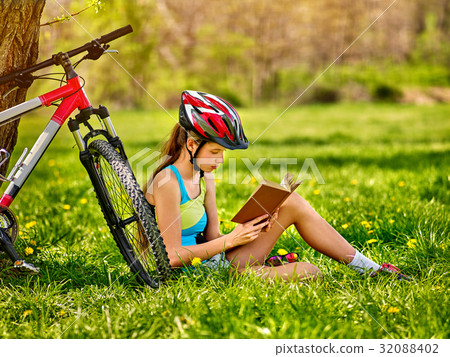 Bikes cycling girl wearing helmet read book rest 32088402