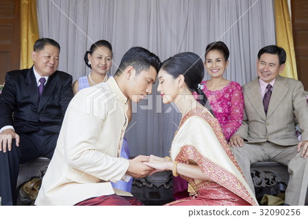 Parents are looking their children and smiling at wedding ceremony of their children 32090256