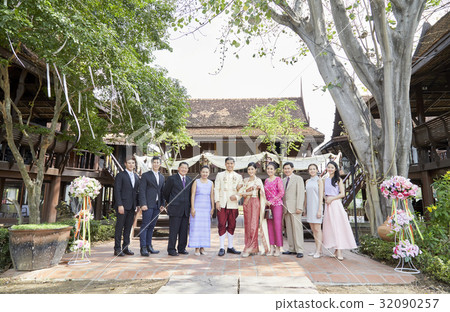 Guests are taking photo with groom and bride. 32090257