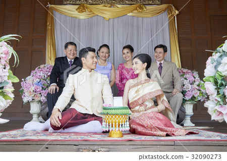 A couple is looking each other and smiling at  their wedding ceremony 32090273