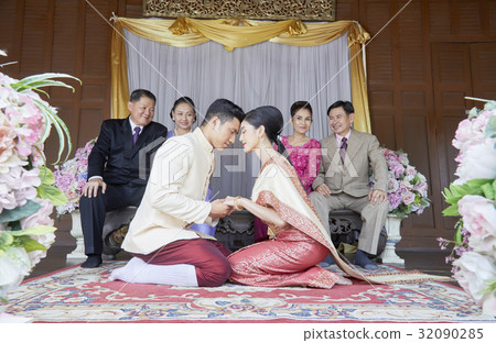 bride and groom are sitting and facing each other bride and groom are sitting and facing each other 32090285