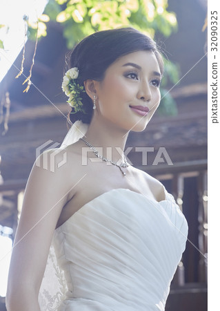 a photo of young bride smiling and looking away a photo of young bride smiling and looking away 32090325