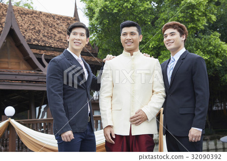 groom and groomsmen are looking at something and smiling 32090392