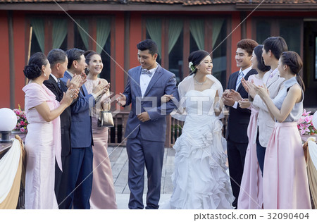 guests are congratulating the bride and groom at wedding reception 32090404