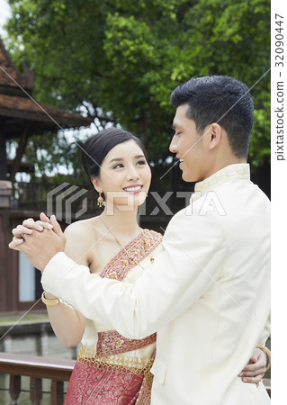 A wife is smiling and looking at her husband when dancing. 32090447