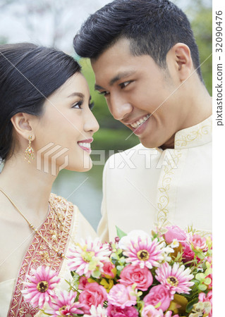 A happy Asian couple is looking at each other  32090476