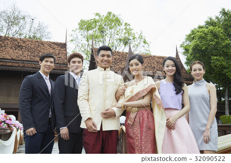 a photo of a couple, two men and two women standing and smiling a photo of a couple, two men and two women standing and smiling 32090522
