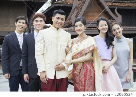 The photo of groom, bride and their friends standing and smiling The photo of groom, bride and their friends standing and smiling 32090524