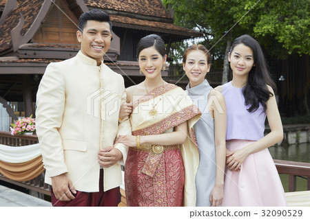 The bride and groom are taking photos with their friends 32090529