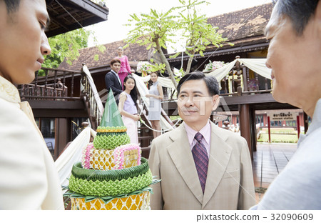 a photo of people looking at a man who is looking at something. 32090609