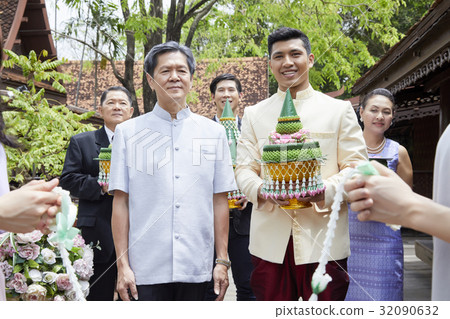 a group of people are holding wedding gifts in a Thai traditional wedding 32090632