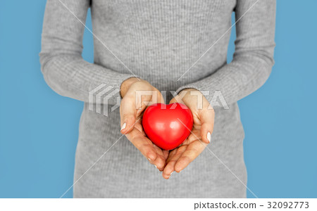 Gentle girl holding a res heart Gentle girl holding a res heart 32092773