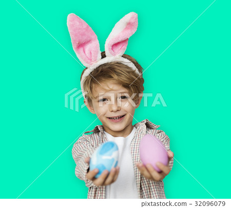 A boy with bunny hairband and easter eggs A boy with bunny hairband and easter eggs 32096079