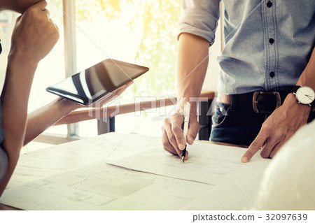 Two Architects engineer discussing  data working and tablet, lap 32097639