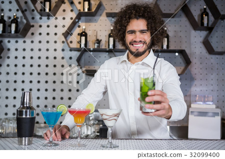 Bartender serving glass of gin 32099400
