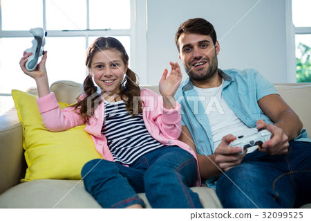 Father and daughter playing video game Father and daughter playing video game 32099525