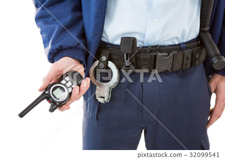 Mid section of security officer holding a walkie-talkie 32099541