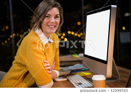 Businesswoman sitting at her desk 32099583