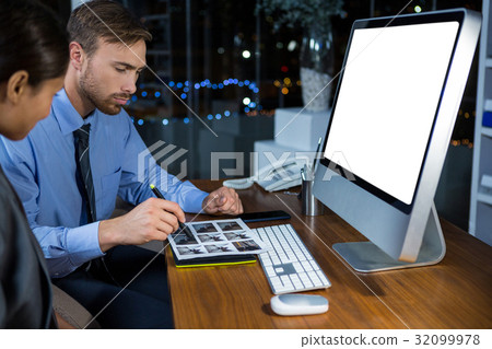 Business executives working on computer with graphic tablet 32099978