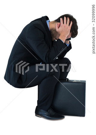 Depressed businessman sitting on steps 32099996