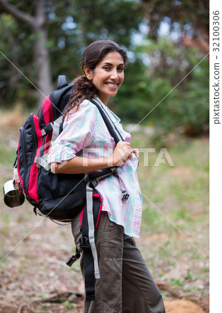Female hiker standing in forest 32100306