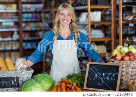 Smiling staff standing in organic section 32100448