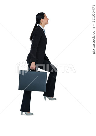 Businesswoman with briefcase walking on stairs 32100475