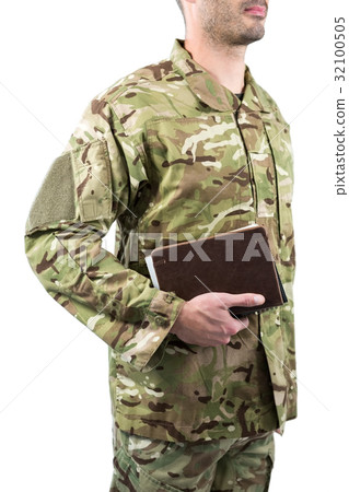 Mid section of soldier holding books Mid section of soldier holding books 32100505