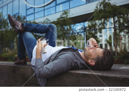 Handsome business executive talking on mobile phone 32100972