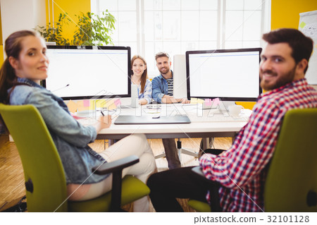 Graphic designers sitting at desk Graphic designers sitting at desk 32101128